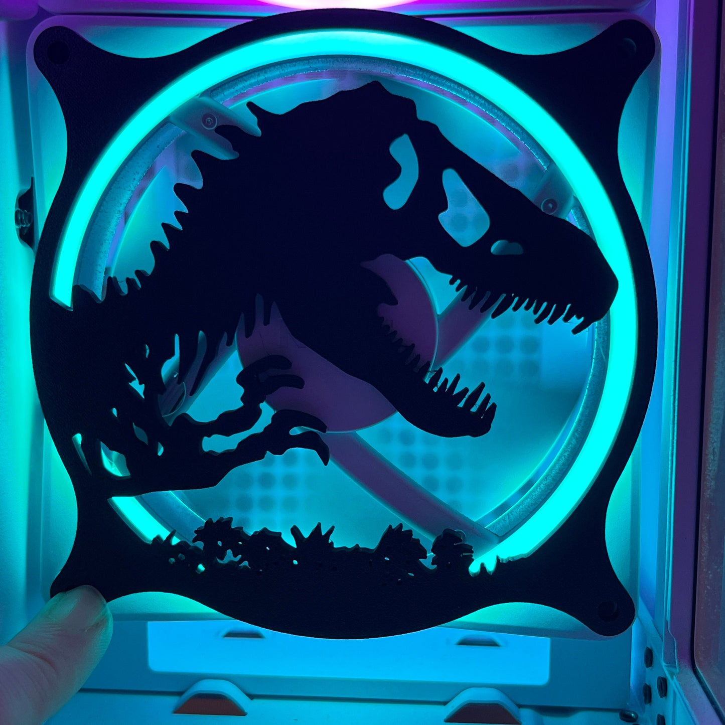 This 3D printed T-Rex dinosaur fan grill cover is perfect for adding a prehistoric touch to your gaming setup. Designed to fit PC fan grills, it adds protection and style. Ideal for dinosaur and gaming enthusiasts alike.