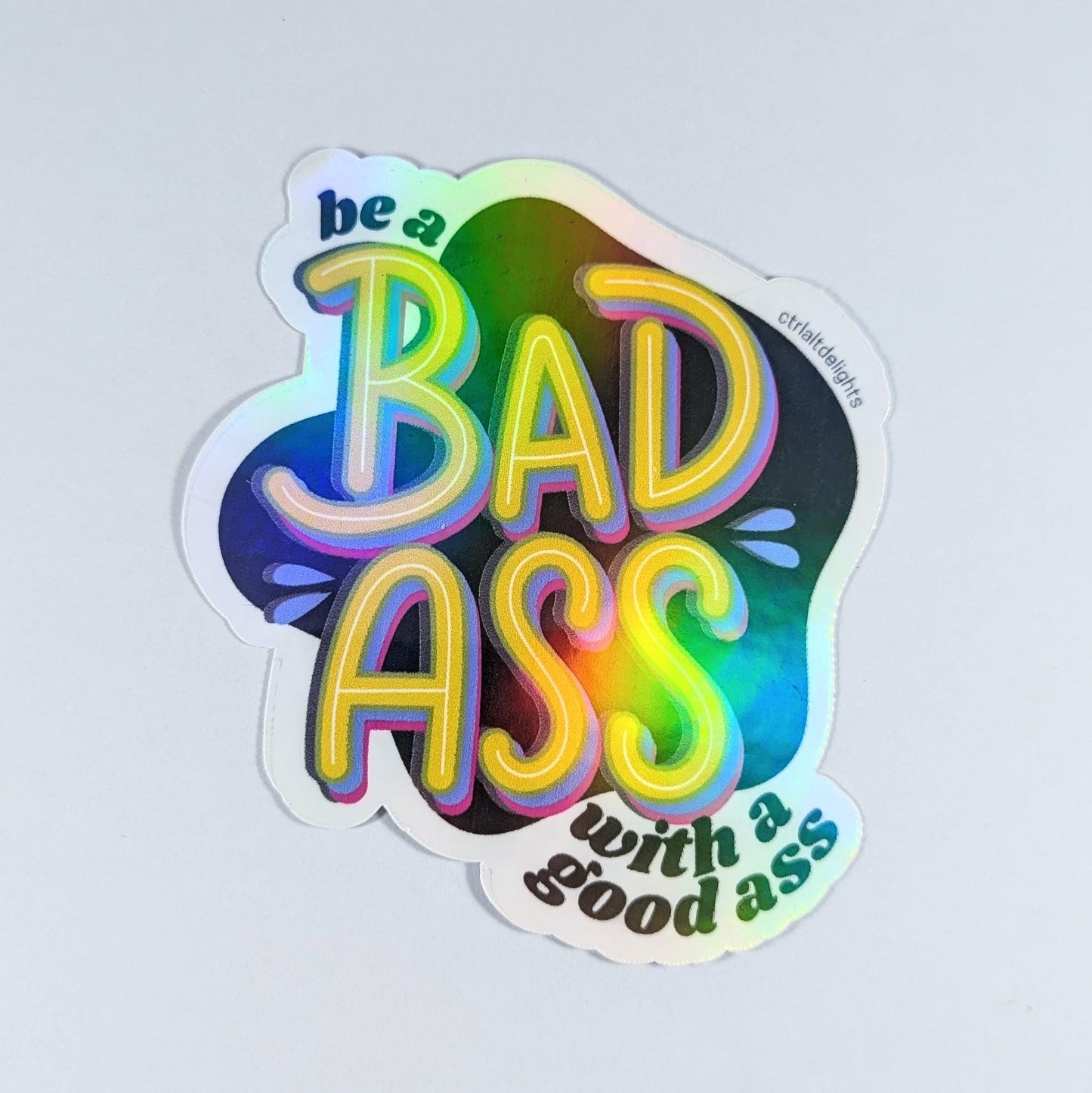 This vibrant vinyl sticker with the phrase 'Be a Badass with a Good Ass' is perfect for adding motivational flair to your laptop, water bottle, or journal. The playful yet bold design is sure to inspire confidence wherever you place it.