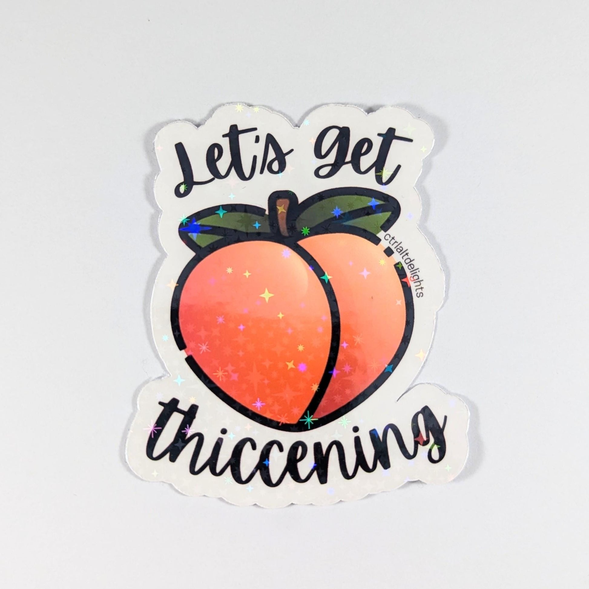 Holographic "Let's Get Thiccening" peach sticker featuring a cute peach design. Perfect for decorating water bottles, laptops, journals, or any surface that needs a fun, thicc touch.