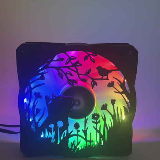 Adorable 3D printed PC fan grill featuring a cat and bird in a garden scene. Adds cozy charm and personality to any gaming or desktop setup.