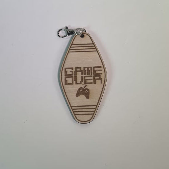 Laser engraved wood motel-style keychain featuring the phrase “Game Over” with a retro controller design. Perfect funny gift for gamers and nostalgia lovers.